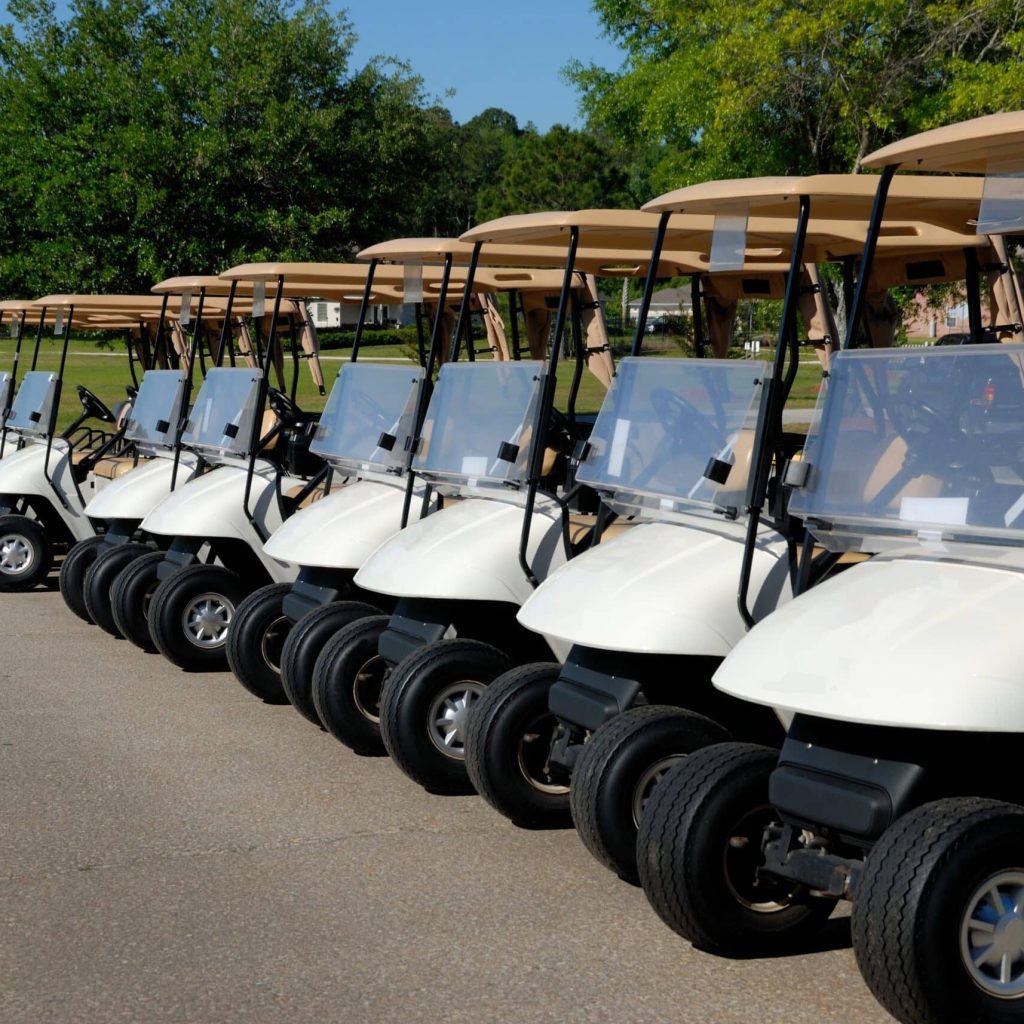 5 golf carts parked up.
